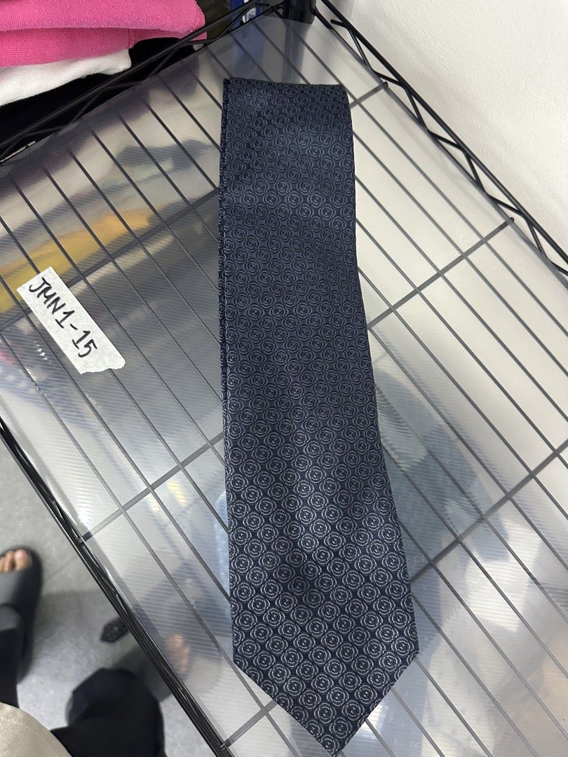 Gucci Silk Tie Made in Italy (Category: Ties) located in Manila. Submitted by declutterpromax (Listing ID 1460197568, Image 1). Description: - Navy Blue Gucci Tie - Features iconic all-over GG pattern - Made from 100% luxurious silk - Expertly crafted in Italy - Adds a touch of sophistication to any outfit.