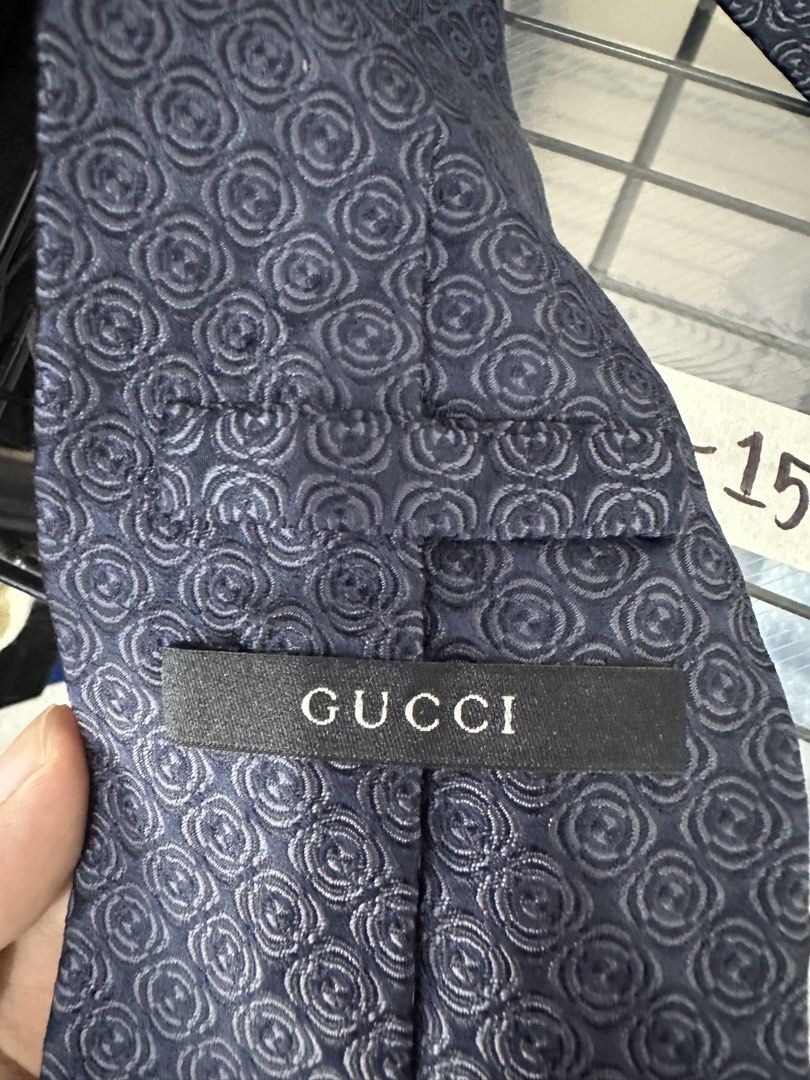 Gucci Silk Tie Made in Italy (Category: Ties) located in Manila. Submitted by declutterpromax (Listing ID 1460197568, Image 3). Description: - Navy Blue Gucci Tie - Features iconic all-over GG pattern - Made from 100% luxurious silk - Expertly crafted in Italy - Adds a touch of sophistication to any outfit.