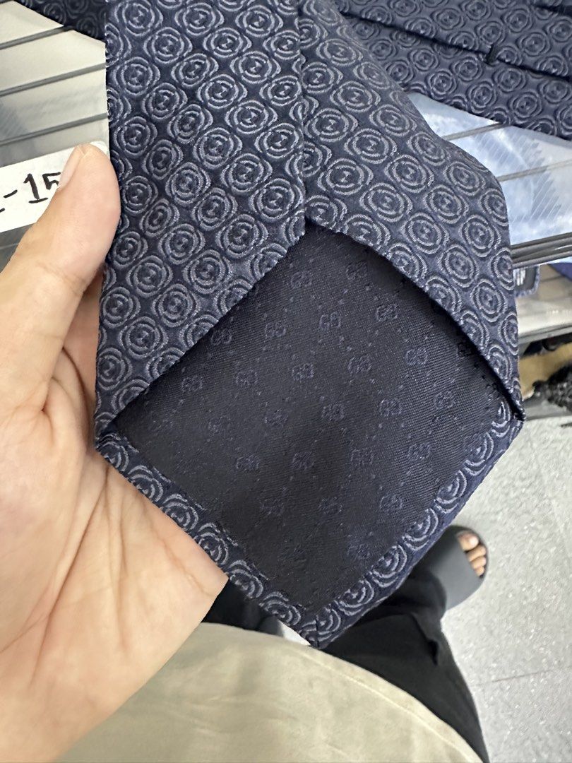 Gucci Silk Tie Made in Italy (Category: Ties) located in Manila. Submitted by declutterpromax (Listing ID 1460197568, Image 2). Description: - Navy Blue Gucci Tie - Features iconic all-over GG pattern - Made from 100% luxurious silk - Expertly crafted in Italy - Adds a touch of sophistication to any outfit.