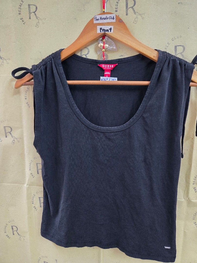 Guess Black Ruched Tie Tank Top Size S (Category: Sleeveless) located in Tarlac. Submitted by resaleclub (Listing ID 1460150569, Image 1). Description: - Stylish Guess tank top - Features flattering ruched detailing on the sides - Adjustable tie closures on the sides - Small, iconic metal Guess logo on the hem - Made in Bangladesh - Measurements: Width 16", Length 19".
