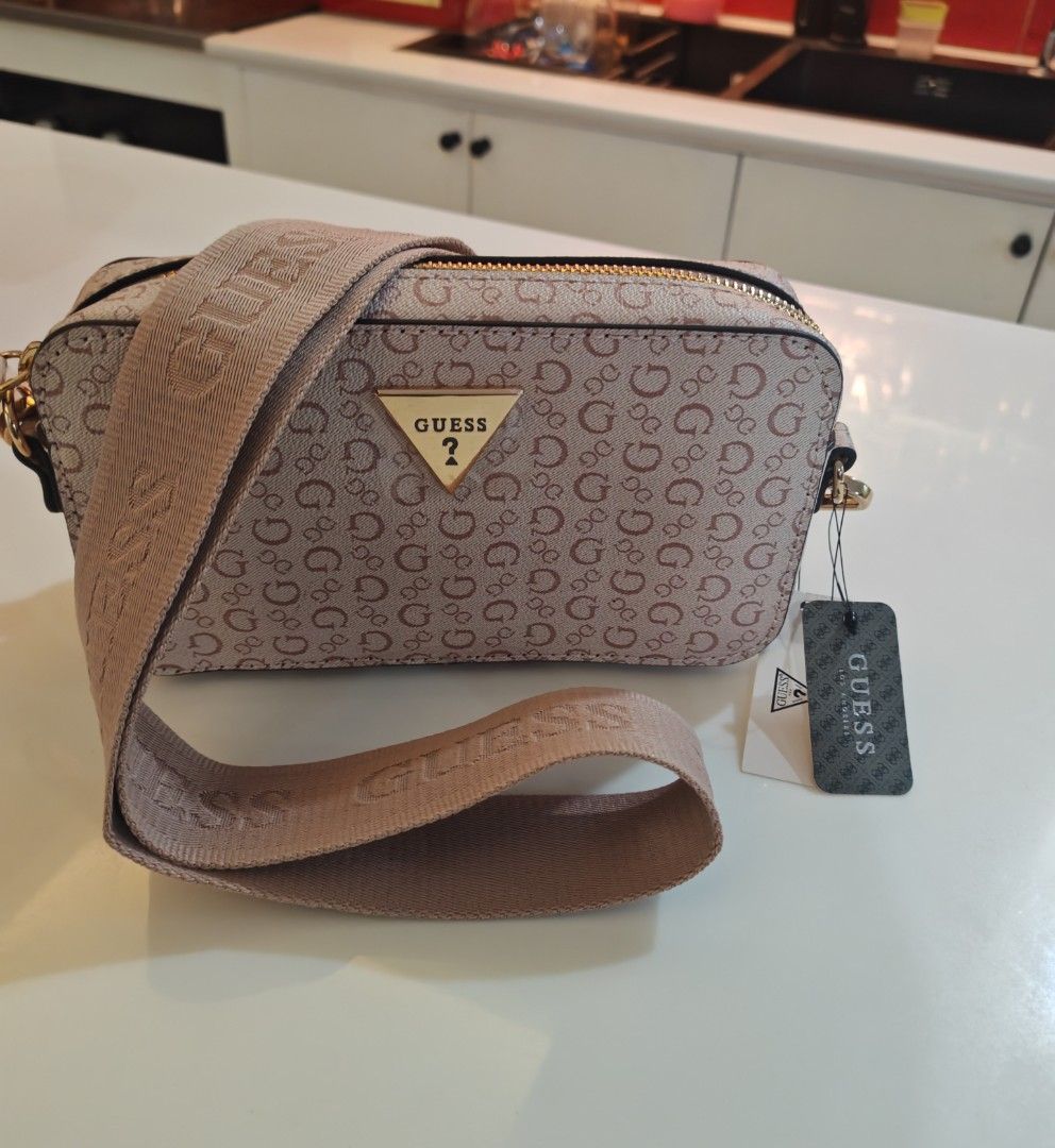 GUESS Crossbody Bag Monogram Pink/Beige (Category: Cross-body Bags) located in Caloocan City. Submitted by det123123 (Listing ID 1460204583, Image 1). Description: Brand new with tags Monogram print design Adjustable GUESS logo strap Gold-tone hardware Zip-top closure Color: Pink/Beige Brand New Perfect for everyday use, travel, or as a gift ✔ Brand new ✔ With original tags ✔ Clean inside and out.