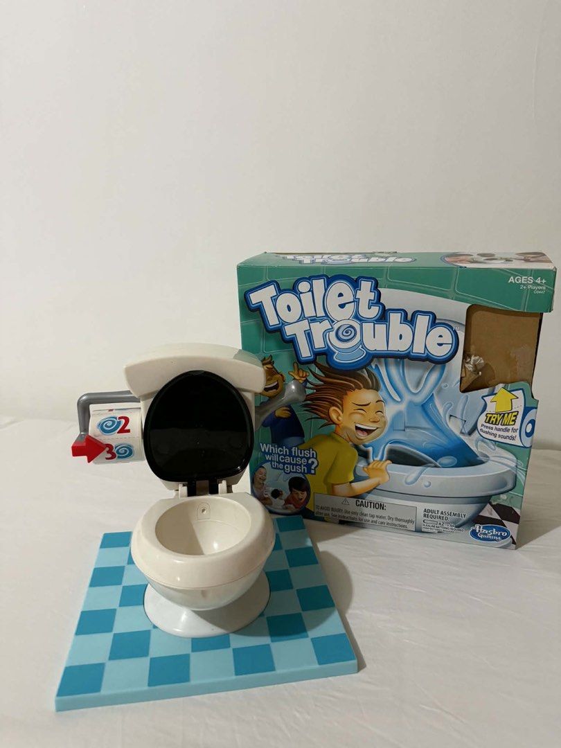 Hasbro Toilet Trouble Game (Category: Board Games & Puzzles) located in Paranaque City. Submitted by shopnichoppy (Listing ID 1460130094, Image 1). Description: - Flush the toilet handle and brace for a surprise spray! - The ultimate game of chance and giggles. - Perfect for family game nights and parties. - Suitable for 2 or more players. - Recommended for ages 4 and up. - Adult assembly required. - Uses clean tap water..