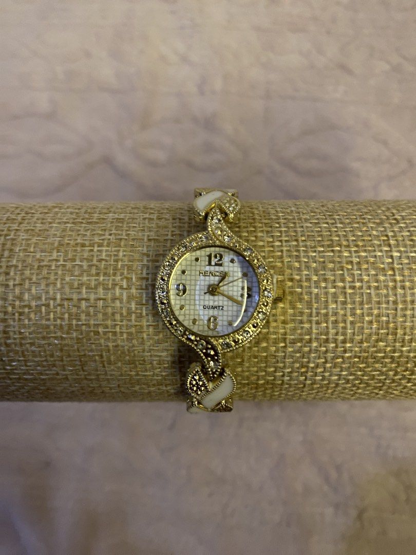Hencen quartz watch- gold (Category: Women's Watches) located in San Fernando. Submitted by curatedchic.bybei (Listing ID 1460188187, Image 1). Description: - Brand: Hencen - Type: Quartz Watch - Color: Gold - Design: Elegant, with intricate strap detail and white accents - Style: Perfect for adding a touch of sophistication to any look.