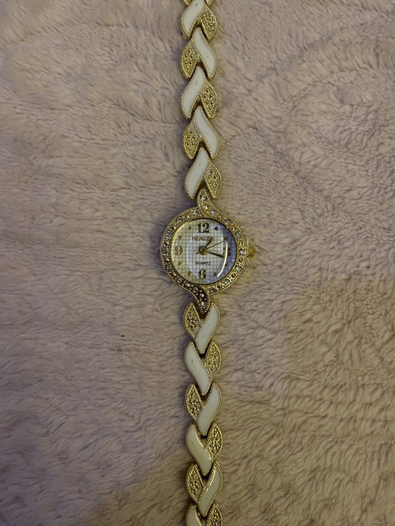 Hencen quartz watch- gold (Category: Women's Watches) located in San Fernando. Submitted by curatedchic.bybei (Listing ID 1460188187, Image 3). Description: - Brand: Hencen - Type: Quartz Watch - Color: Gold - Design: Elegant, with intricate strap detail and white accents - Style: Perfect for adding a touch of sophistication to any look.