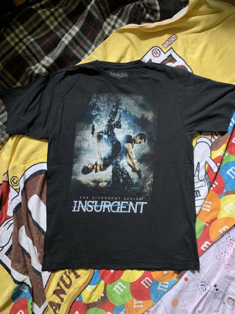 Insurgent movie tee (Category: Tshirts & Polo Shirts ) located in Cagayan de Oro. Submitted by premium_thrifts (Listing ID 1460120431, Image 1). Description: Black colorway. Good condition. Issue: slight fades, crackprint and small loose stitchings on the left sleeve - MEASUREMENTS: L28" x W20" 18" (shoulder to shoulder) 8.8" (sleeve length) Fits Medium Add shipping fee (via JRS or J&T).
