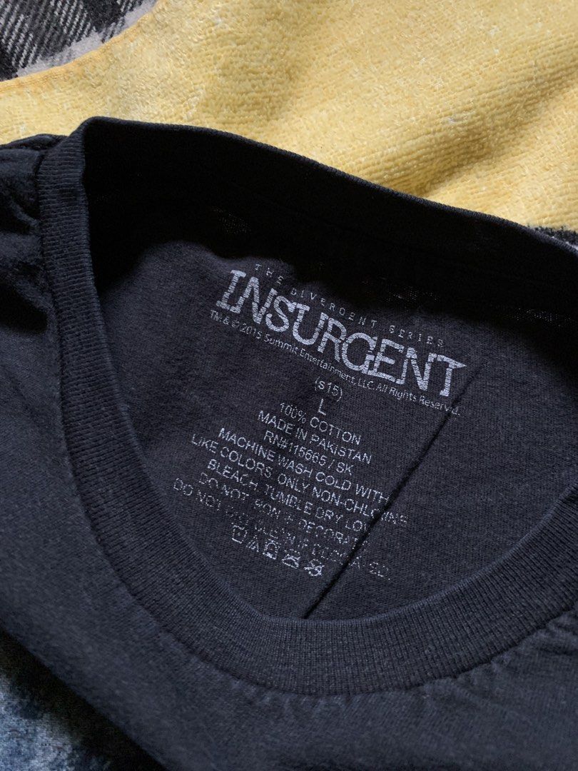 Insurgent movie tee (Category: Tshirts & Polo Shirts ) located in Cagayan de Oro. Submitted by premium_thrifts (Listing ID 1460120431, Image 3). Description: Black colorway. Good condition. Issue: slight fades, crackprint and small loose stitchings on the left sleeve - MEASUREMENTS: L28" x W20" 18" (shoulder to shoulder) 8.8" (sleeve length) Fits Medium Add shipping fee (via JRS or J&T).
