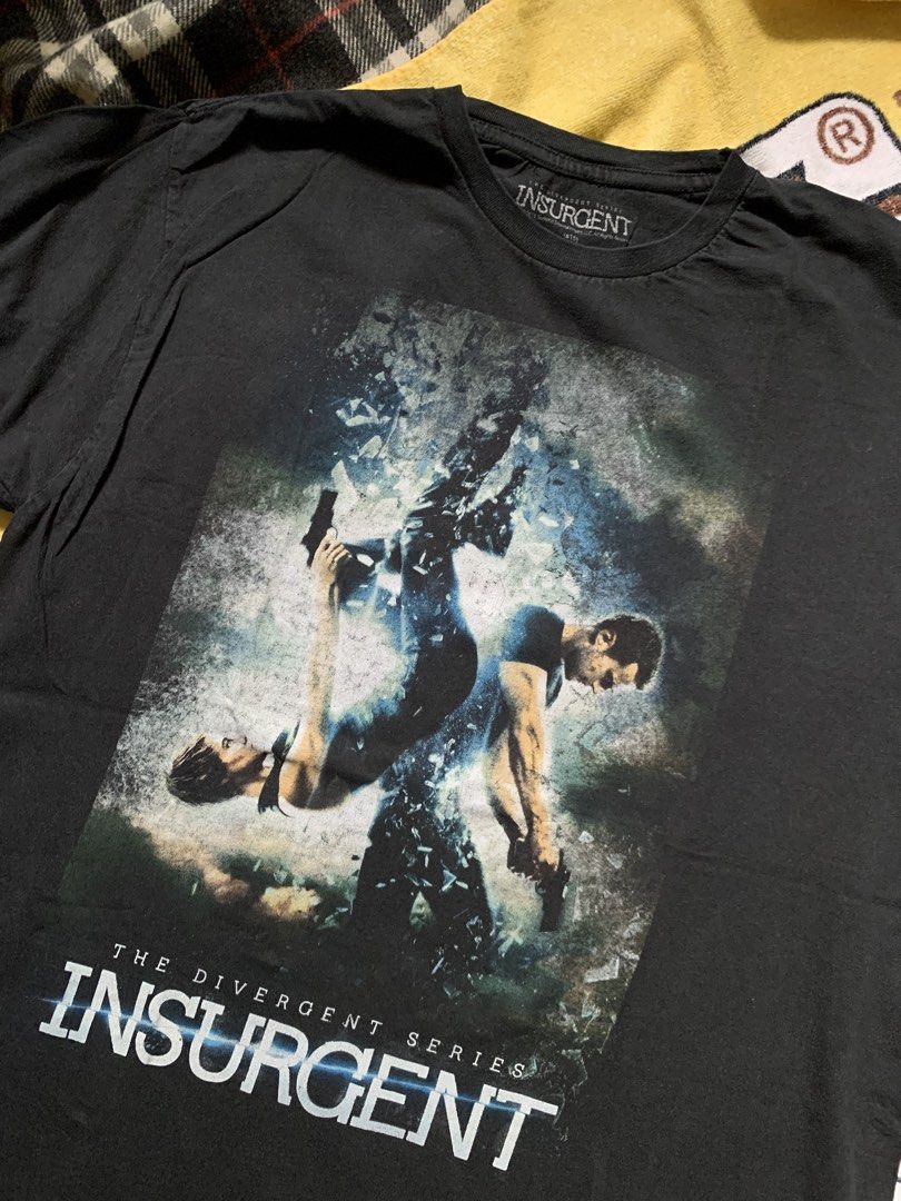 Insurgent movie tee (Category: Tshirts & Polo Shirts ) located in Cagayan de Oro. Submitted by premium_thrifts (Listing ID 1460120431, Image 2). Description: Black colorway. Good condition. Issue: slight fades, crackprint and small loose stitchings on the left sleeve - MEASUREMENTS: L28" x W20" 18" (shoulder to shoulder) 8.8" (sleeve length) Fits Medium Add shipping fee (via JRS or J&T).