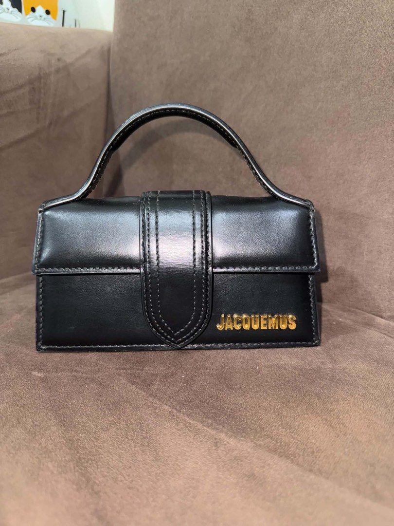 Jacquemus Black Leather Mini Bag (Category: Luxury Bags & Wallets) located in Manila. Submitted by ilvoelv (Listing ID 1460214951, Image 2). Description: - Authentic Jacquemus mini bag in black - Made from premium leather - Features a signature gold logo on the front - Elegant top handle design - Compact and small, ideal for carrying essentials.