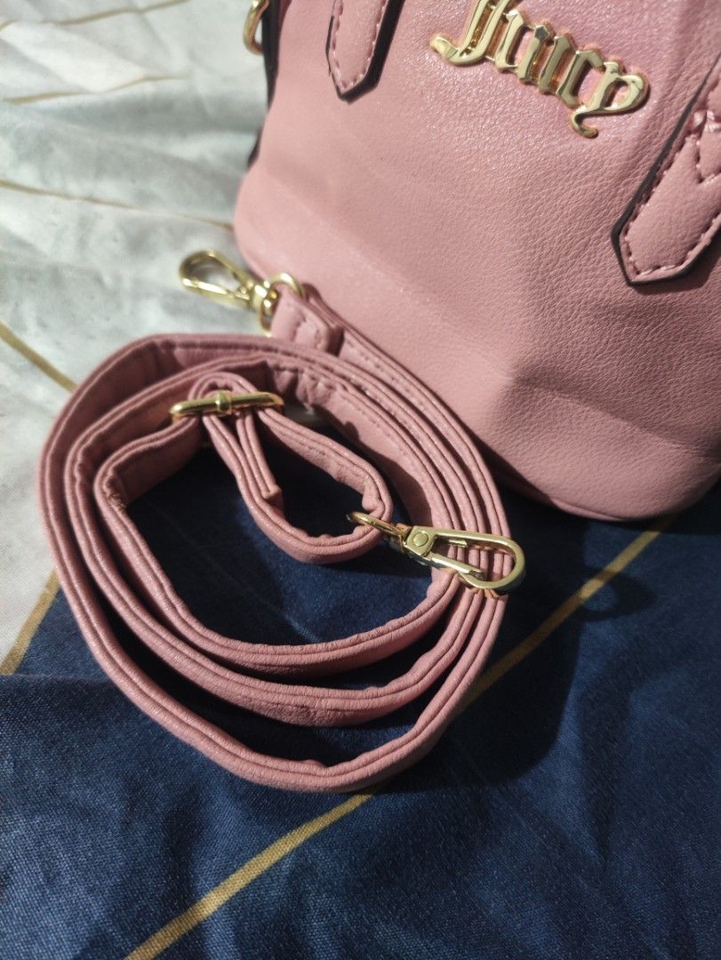 Juicy Couture Pink Mini Handbag with Strap (Category: Luxury Bags & Wallets) located in Rizal. Submitted by itsyoboiadji (Listing ID 1460268310, Image 3). Description: - Cute pink mini handbag - Brand: Juicy Couture - Features a top handle - Includes a detachable crossbody strap - Interior lining with all-over Juicy Couture logo - Made in Cambodia - Ideal for carrying your essentials - As new condition .