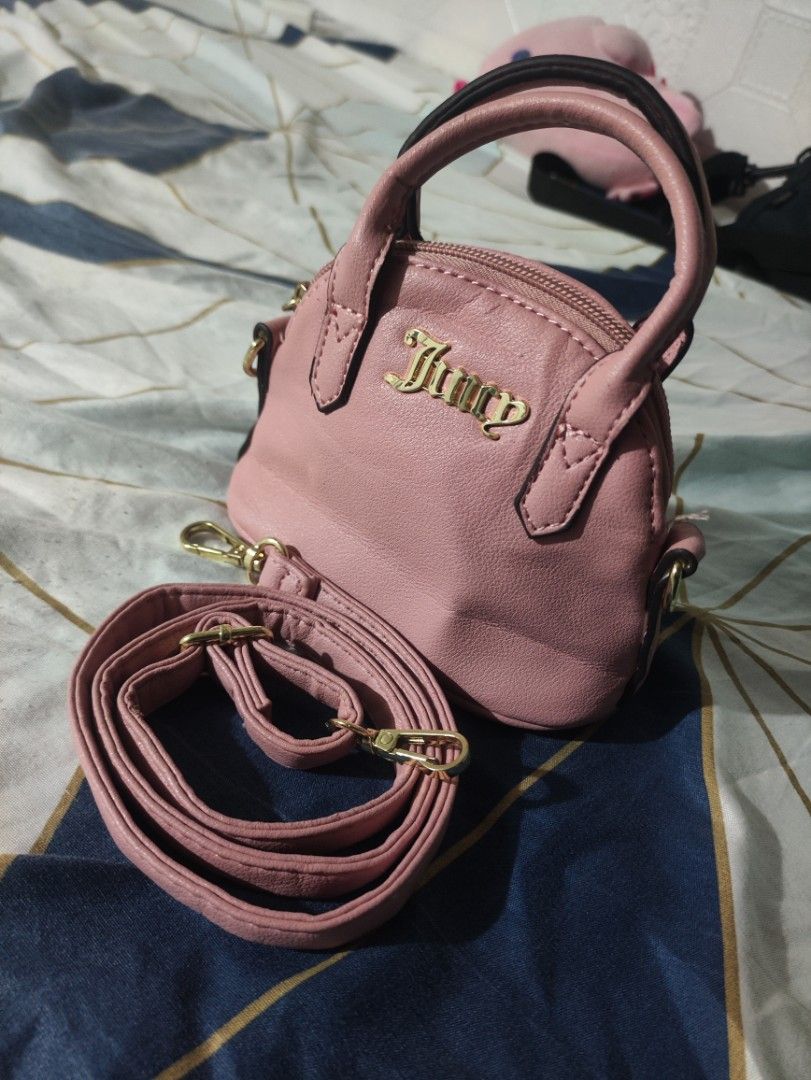 Juicy Couture Pink Mini Handbag with Strap (Category: Luxury Bags & Wallets) located in Rizal. Submitted by itsyoboiadji (Listing ID 1460268310, Image 2). Description: - Cute pink mini handbag - Brand: Juicy Couture - Features a top handle - Includes a detachable crossbody strap - Interior lining with all-over Juicy Couture logo - Made in Cambodia - Ideal for carrying your essentials - As new condition .