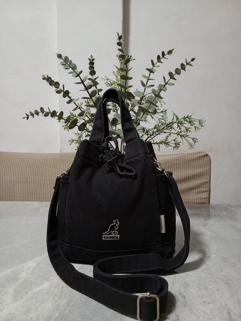 Kangol Black Canvas Bucket Bag with Shoulder Strap (Category: Cross-body Bags) located in Manila. Submitted by cosmiccloud-9236 (Listing ID 1460207727, Image 1). Description: - Brand: Kangol - Color: Black - Style: Bucket Bag - Material: Canvas - Features: Top handles, adjustable shoulder strap, drawstring closure, two side pockets - Ideal for: Everyday use.