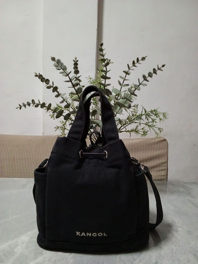 Kangol Black Canvas Bucket Bag with Shoulder Strap (Category: Cross-body Bags) located in Manila. Submitted by cosmiccloud-9236 (Listing ID 1460207727, Image 2). Description: - Brand: Kangol - Color: Black - Style: Bucket Bag - Material: Canvas - Features: Top handles, adjustable shoulder strap, drawstring closure, two side pockets - Ideal for: Everyday use.