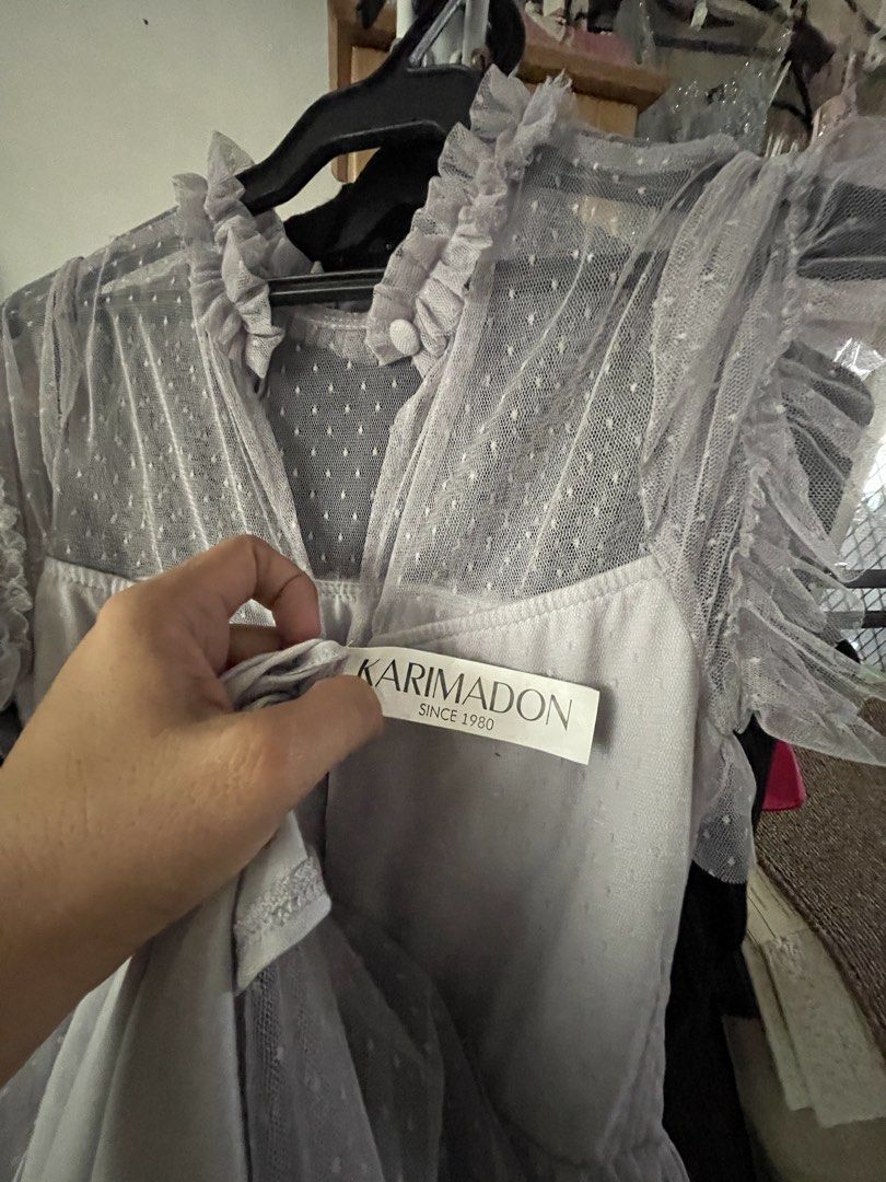 KARIMADON Grey Tulle Ruffle Dress (Category: Dresses) located in Mandaluyong City. Submitted by coolmeybab (Listing ID 1460144573, Image 3). Description: - Elegant grey dress with a charming polka dot tulle overlay. - Features a delicate ruffled neckline and sleeves. - Designed with a stylish tiered skirt. - Convenient zipper closure at the back. - Ideal for parties, events, or any special occasion. - Offers both comfort and a fashionable look..