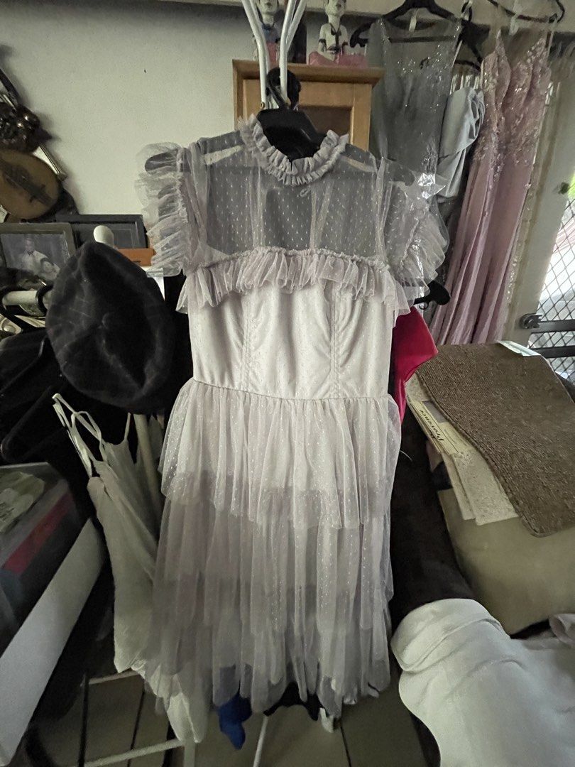 KARIMADON Grey Tulle Ruffle Dress (Category: Dresses) located in Mandaluyong City. Submitted by coolmeybab (Listing ID 1460144573, Image 2). Description: - Elegant grey dress with a charming polka dot tulle overlay. - Features a delicate ruffled neckline and sleeves. - Designed with a stylish tiered skirt. - Convenient zipper closure at the back. - Ideal for parties, events, or any special occasion. - Offers both comfort and a fashionable look..