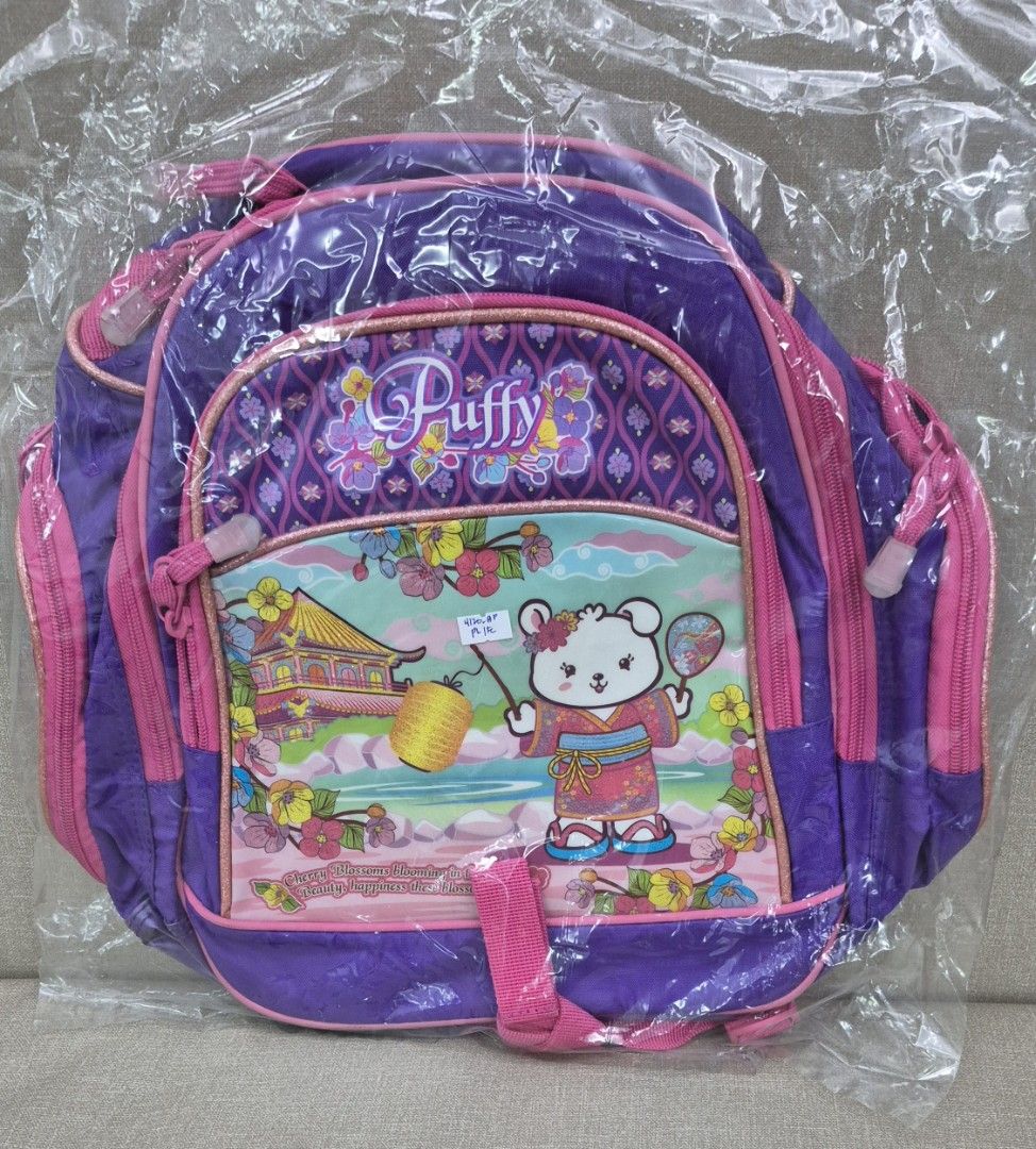 Kids Backpack (Category: Backpacks) located in Quezon City. Submitted by akcstuff (Listing ID 1460108134, Image 1). Description: Color: Purple and pink size: 15in x 15in Brand new (sealed) Good quality (thick canvas) With 2 zippered side pockets for water bottle / pencil case Location: Mariana QC.