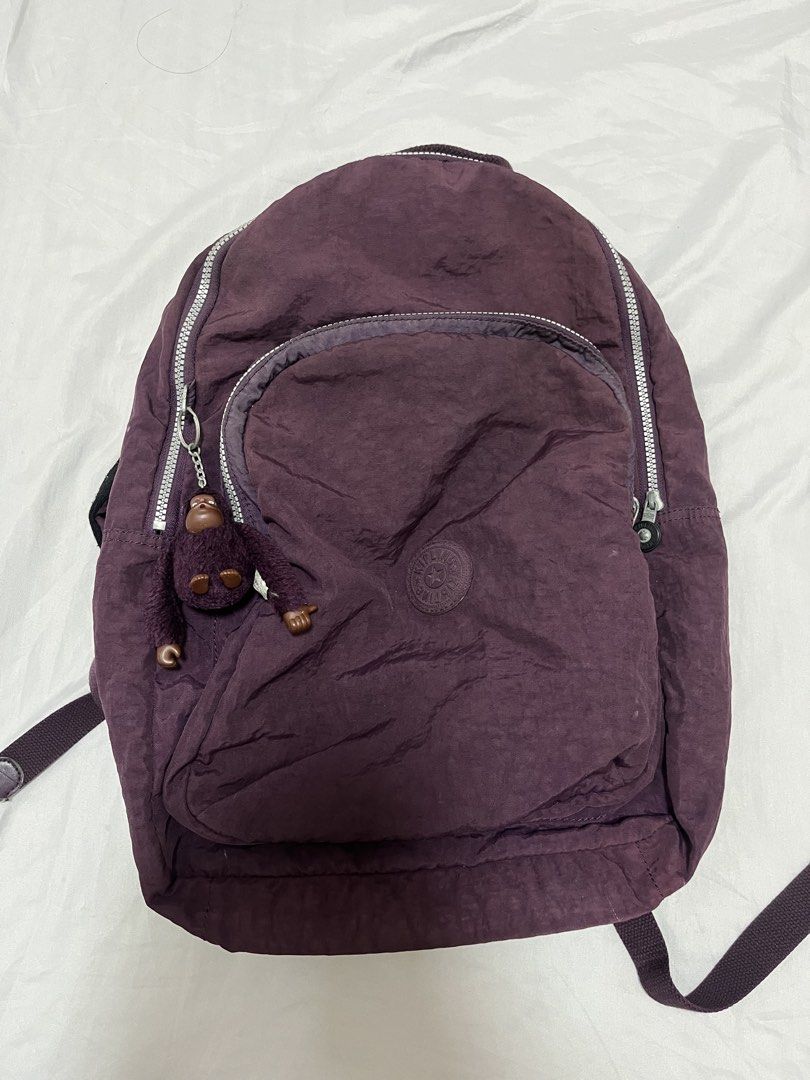 Kipling Purple Backpack with Monkey Charm (Category: Backpacks) located in Naga. Submitted by raddeyy (Listing ID 1460274334, Image 1). Description: - Authentic Kipling backpack with signature monkey charm. - Features multiple zippered compartments for excellent organization. - Durable fabric with a unique crinkled texture. - Adjustable straps for a comfortable, customized fit. - Spacious interior, ideal for daily essentials or travel needs. - ca