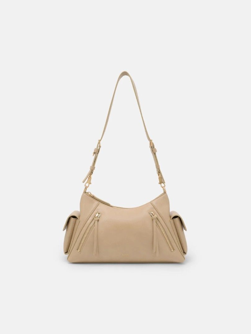 Kristen Shoulder Bag - Beige (Category: Announcements) located in Makati City. Submitted by zoeppe_online (Listing ID 1460298739, Image 1). Description: Defined by a utilitarian-inspired aesthetic, this slouchy shoulder bag is punctuated by functional zip details and structured side pockets. It features a wide, adjustable strap with polished hardware for a customizable fit. A contemporary take on the carry-all, balancing tactile softness with a c