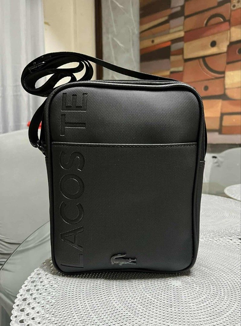 Lacoste Black Textured Crossbody Bag (Category: Sling Bags) located in Manila. Submitted by sonchan2point4 (Listing ID 1460109743, Image 1). Description: 2024 bought no issues, still good condition - Authentic Black Lacoste Crossbody Bag - Textured material with embossed "LACOSTE" lettering - Iconic crocodile logo detail - Secure zipper closure - Adjustable strap for comfortable wear - Ideal for everyday use and carrying essentials.