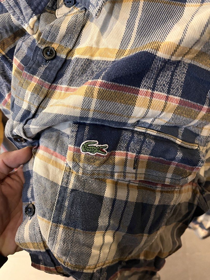 Lacoste Regular Fit Plaid Flannel Shirt (Category: Tshirts & Polo Shirts ) located in Manila. Submitted by jaspermack50866 (Listing ID 1460191626, Image 2). Description: - Classic plaid flannel shirt from Lacoste - Regular fit - Two chest pockets with button closures - Iconic embroidered Lacoste crocodile logo on left pocket - Button-down front - Versatile for layering or standalone wear.