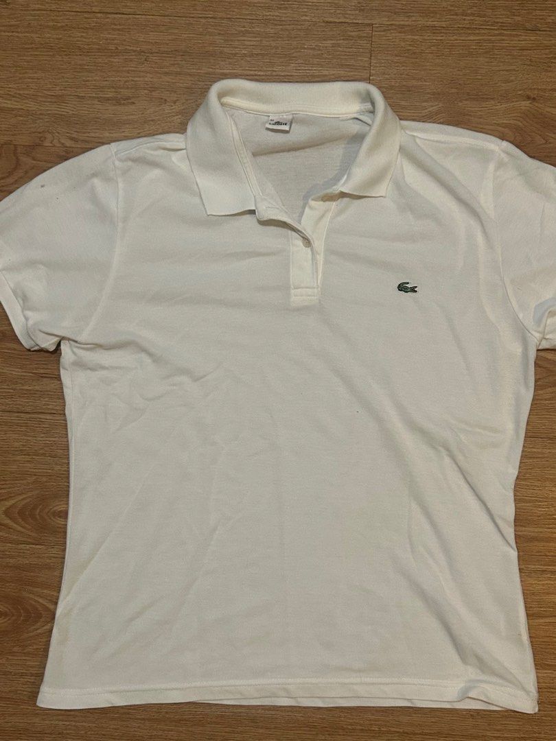 Lacoste White Polo Shirt (Category: Tshirts & Polo Shirts ) located in Manila. Submitted by silentowl_7cf53c (Listing ID 1460246431, Image 1). Description: - Classic white Lacoste polo shirt - Features iconic green crocodile logo - Short sleeves - Collared neckline - Versatile for casual or smart-casual outfits.