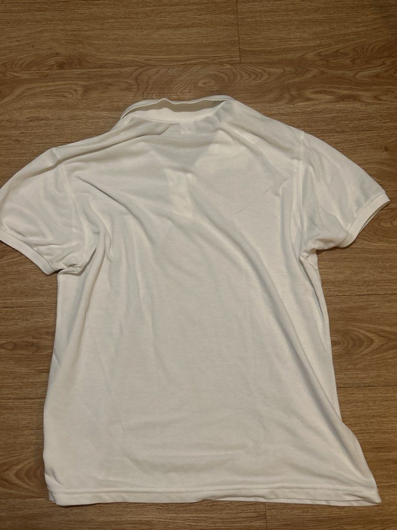 Lacoste White Polo Shirt (Category: Tshirts & Polo Shirts ) located in Manila. Submitted by silentowl_7cf53c (Listing ID 1460246431, Image 2). Description: - Classic white Lacoste polo shirt - Features iconic green crocodile logo - Short sleeves - Collared neckline - Versatile for casual or smart-casual outfits.
