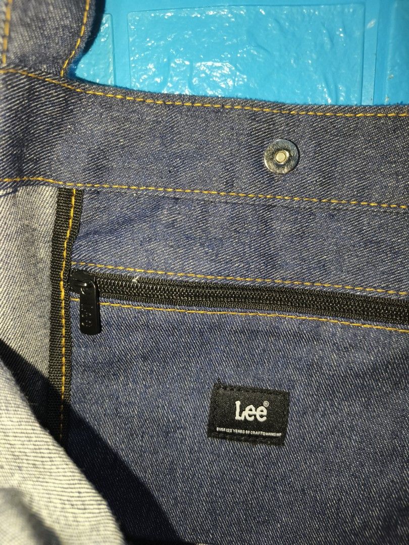 Lee Denim Tote Bag (Category: Tote Bags) located in Davao. Submitted by vndrgd (Listing ID 1460114740, Image 3). Description: - Classic Lee denim tote bag - Dark wash blue color - Front pocket for easy access - Inner zip pocket for secure storage - Snap button closure - Sturdy and reliable straps - Ideal for everyday use - Approximate dimensions: 12" W x 14" L.