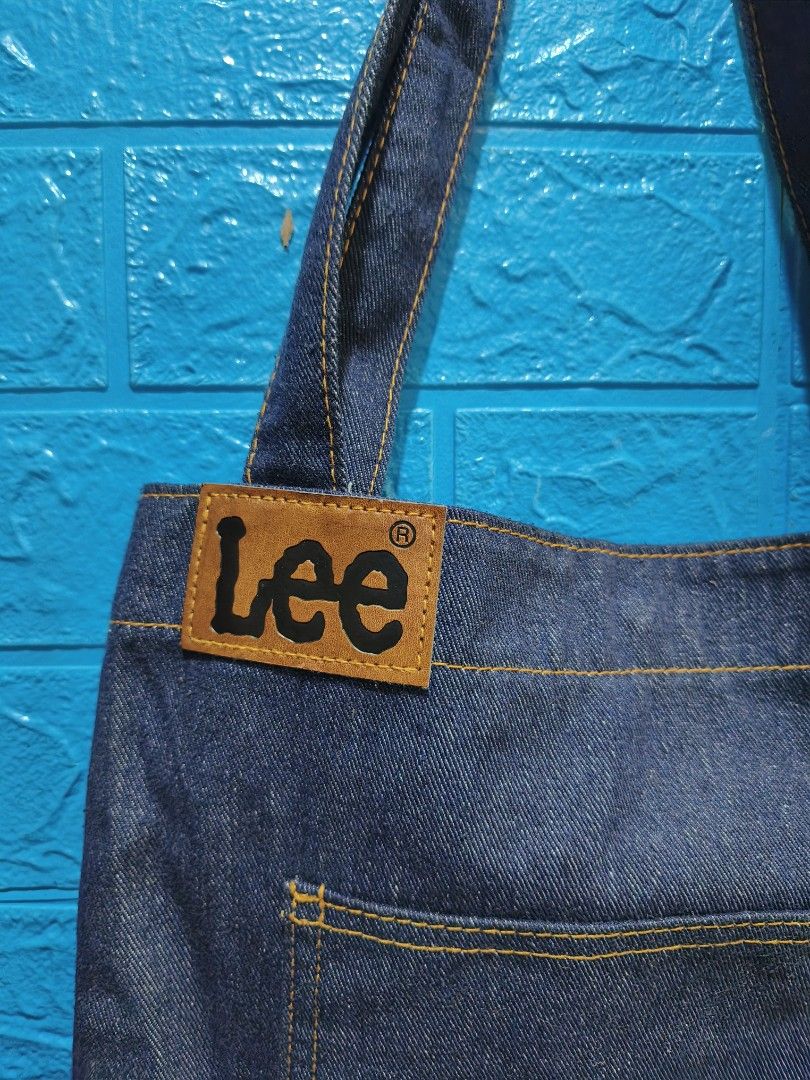 Lee Denim Tote Bag (Category: Tote Bags) located in Davao. Submitted by vndrgd (Listing ID 1460114740, Image 2). Description: - Classic Lee denim tote bag - Dark wash blue color - Front pocket for easy access - Inner zip pocket for secure storage - Snap button closure - Sturdy and reliable straps - Ideal for everyday use - Approximate dimensions: 12" W x 14" L.
