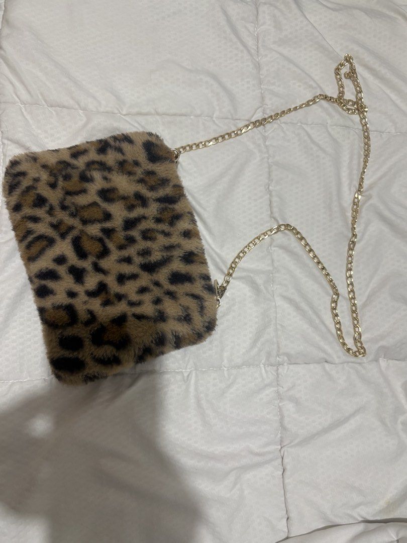 leopard sling (Category: Sling Bags) located in Manila. Submitted by nykji96 (Listing ID 1460251816, Image 1). Description: - Trendy leopard print design - Soft and plush faux fur material - Elegant gold chain strap - Perfect for adding a stylish touch to any outfit - Compact and chic for essentials.