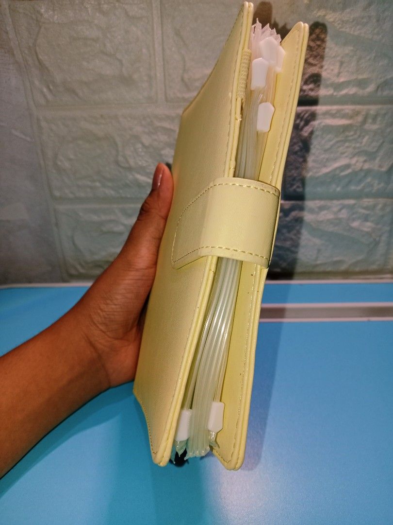 Light Yellow Leather Budget Planner with Snap Closure (Category: Stationery & School Supplies) located in Manila. Submitted by imaiano (Listing ID 1460193562, Image 3). Description: - Cute light yellow budget binder/planner - Durable PU leather material - Lightly used, not dirty - Simple and clean design - Unbranded, with printed budget sheet inserts.
