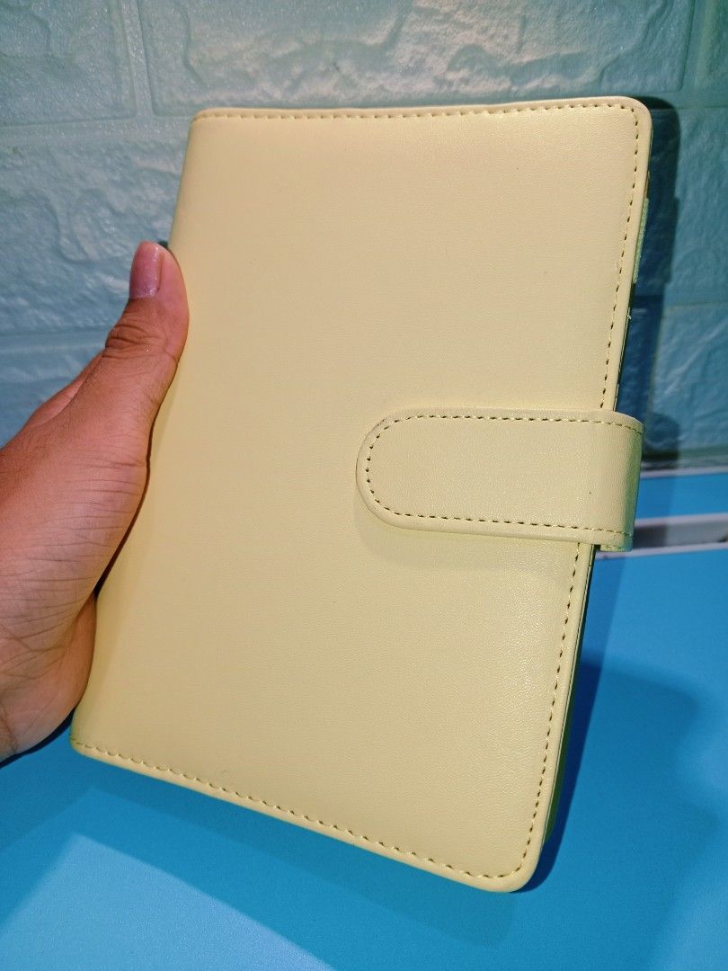 Light Yellow Leather Budget Planner with Snap Closure (Category: Stationery & School Supplies) located in Manila. Submitted by imaiano (Listing ID 1460193562, Image 1). Description: - Cute light yellow budget binder/planner - Durable PU leather material - Lightly used, not dirty - Simple and clean design - Unbranded, with printed budget sheet inserts.