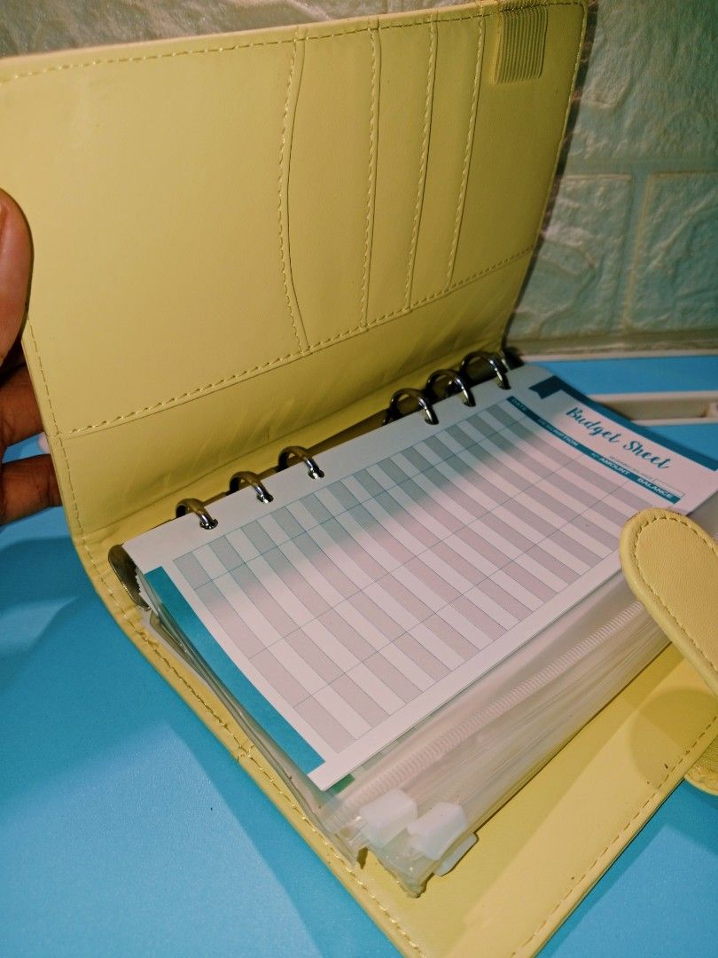 Light Yellow Leather Budget Planner with Snap Closure (Category: Stationery & School Supplies) located in Manila. Submitted by imaiano (Listing ID 1460193562, Image 2). Description: - Cute light yellow budget binder/planner - Durable PU leather material - Lightly used, not dirty - Simple and clean design - Unbranded, with printed budget sheet inserts.