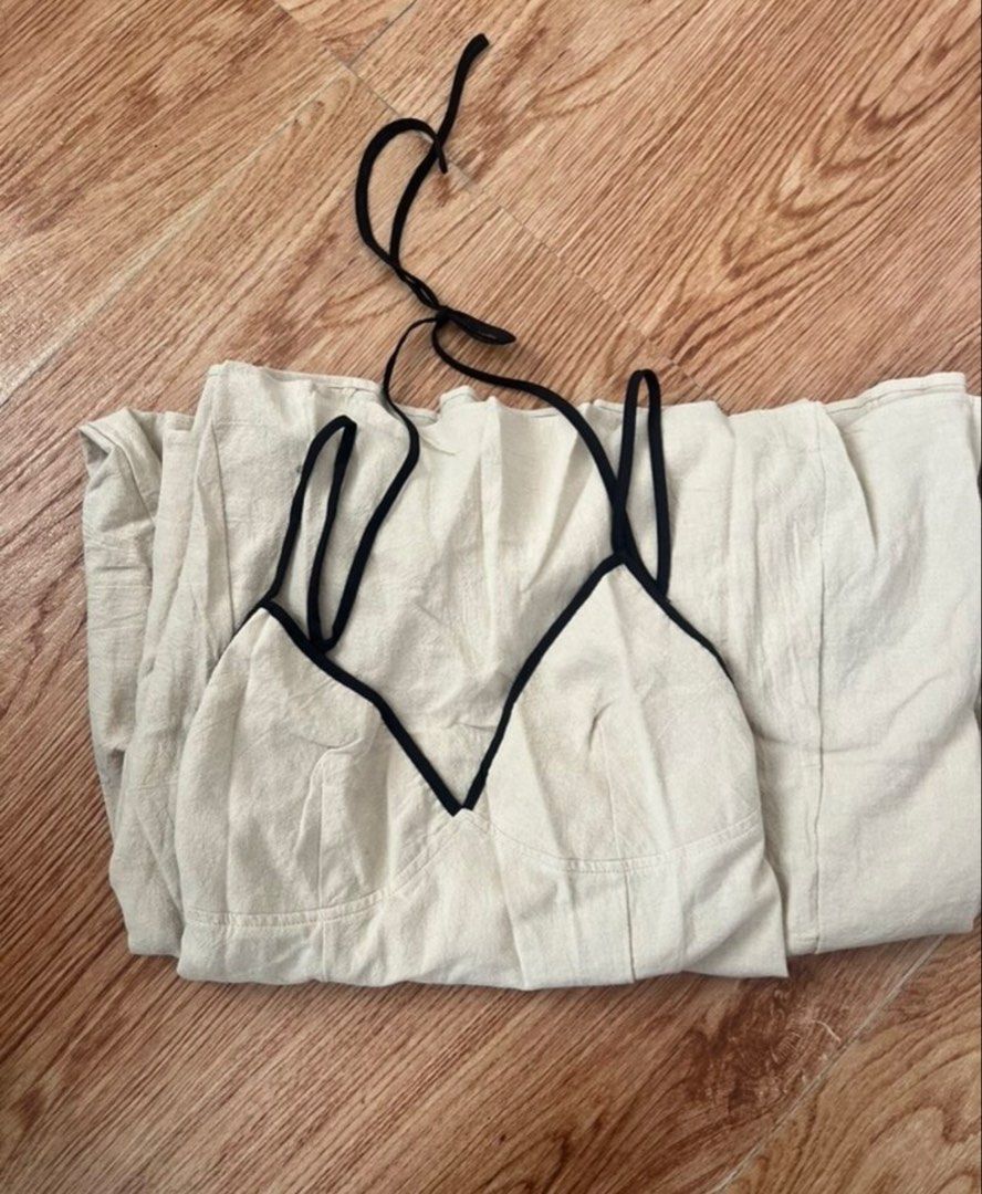 Linen Backless Dress (Category: Dresses) located in Manila. Submitted by cassyandco. (Listing ID 1460169459, Image 1). Description: - Cream midi slip dress - Black trim detail - Spaghetti straps - Versatile: great for casual outings or nights out - Comfortable and stylish - Ideal for summer wear.