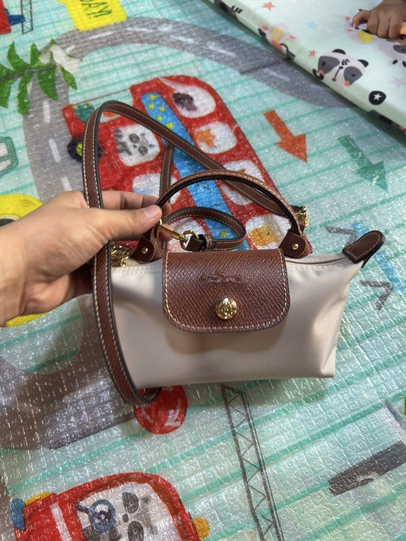 Longchamp Le Pliage crossbody bag beige (Category: Luxury Bags & Wallets) located in San Mateo. Submitted by rkg_agbayani (Listing ID 1459331659, Image 2). Description: - Authentic Beige Longchamp Le Pliage crossbody bag - Genuine leather trim and strap - Elegant gold hardware - Secure zip closure with snap button flap - Compact and ideal for everyday use.