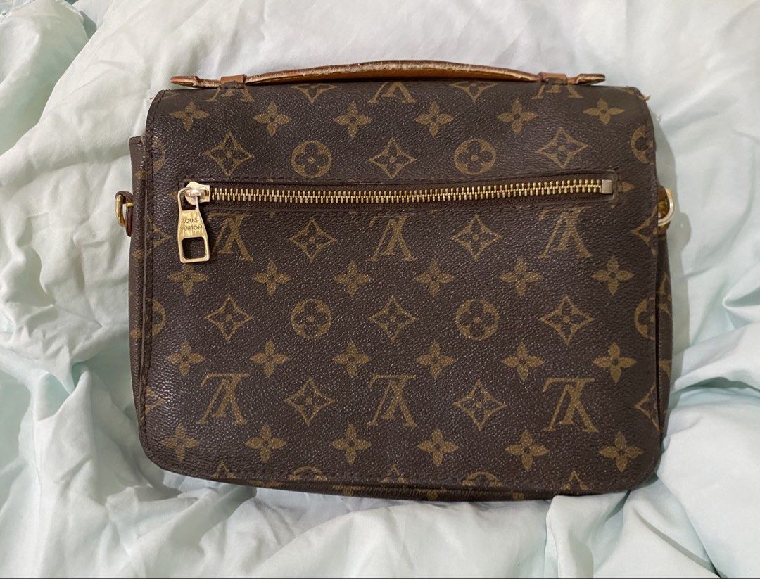 Louis Vuitton Monogram Canvas Shoulder Bag (Category: Luxury Bags & Wallets) located in San Fernando. Submitted by mackiehelena0000 (Listing ID 1460116553, Image 1). Description: - Classic Louis Vuitton monogram canvas shoulder bag - Features a front zip pocket - Secure clasp closure - Leather trim shows some wear, especially on the handle - Gold-tone hardware - Timeless addition to your collection.