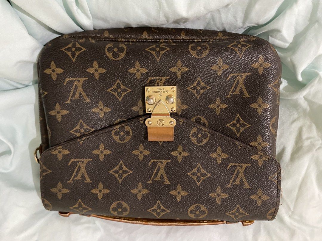 Louis Vuitton Monogram Canvas Shoulder Bag (Category: Luxury Bags & Wallets) located in San Fernando. Submitted by mackiehelena0000 (Listing ID 1460116553, Image 2). Description: - Classic Louis Vuitton monogram canvas shoulder bag - Features a front zip pocket - Secure clasp closure - Leather trim shows some wear, especially on the handle - Gold-tone hardware - Timeless addition to your collection.