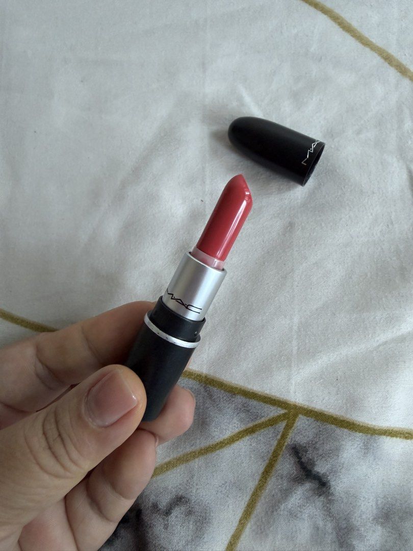 MAC Lipstick (Category: Makeup) located in Mandaluyong City. Submitted by xthinejavier (Listing ID 1460197697, Image 2). Description: - MAC Lipstick mini size - Classic black case - Shade: Tropic Tonic (Coral-pink shade) - Condition: Only swatched once on arm - Plenty of product remaining - Ideal for everyday wear or adding a pop of color.