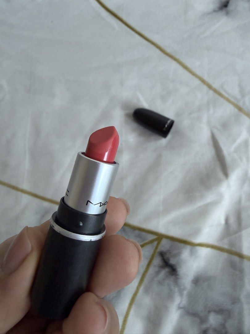 MAC Lipstick (Category: Makeup) located in Mandaluyong City. Submitted by xthinejavier (Listing ID 1460197697, Image 3). Description: - MAC Lipstick mini size - Classic black case - Shade: Tropic Tonic (Coral-pink shade) - Condition: Only swatched once on arm - Plenty of product remaining - Ideal for everyday wear or adding a pop of color.