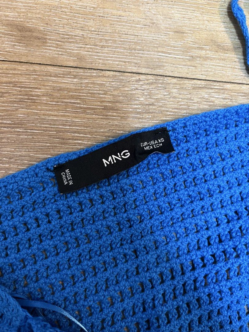 Mango Blue Crochet Halter Neck Top (Category: Sleeveless) located in Pasig City. Submitted by d_cluttered (Listing ID 1460241417, Image 3). Description: - MNG crochet halter neck top - Size XS - Features a scalloped hem - Tie-up straps - Ideal for beach days or festivals.