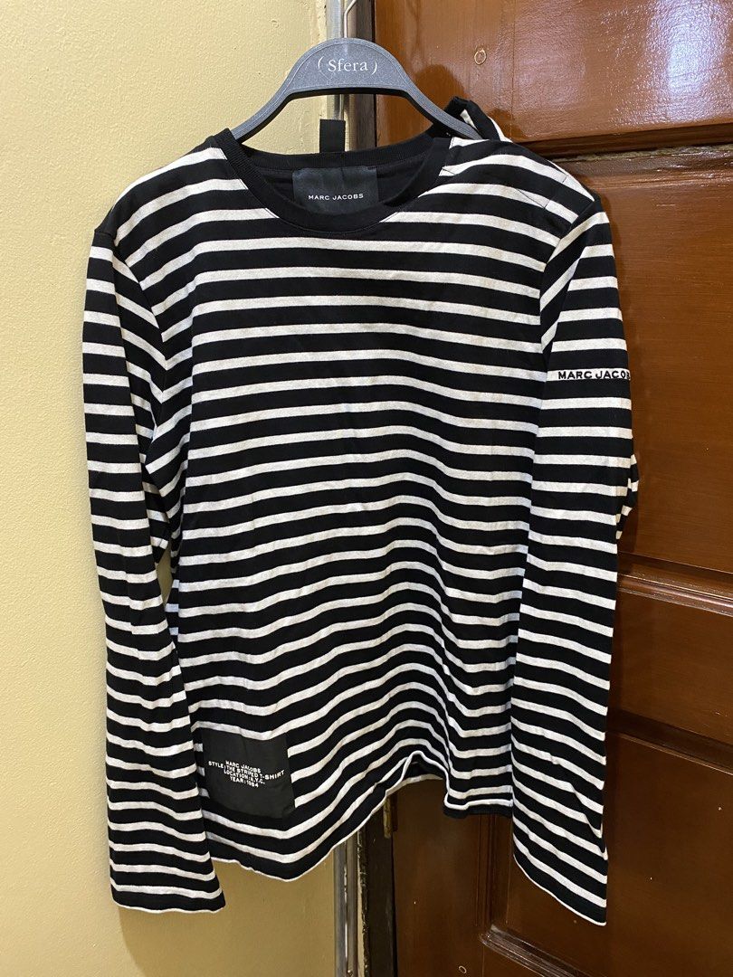 Marc Jacobs Striped Long Sleeve Shirt (Category: Longsleeves) located in Manila. Submitted by haveago0dthrift (Listing ID 1460151296, Image 2). Description: - Classic black and white striped long-sleeved shirt - Brand: Marc Jacobs - Subtle brand name detail on sleeve - Larger tag detail on the side - Material: 100% Cotton - Made in Portugal - Comfortable and stylish for everyday wear - Versatile wardrobe staple - Width 1.5 - Length 4.