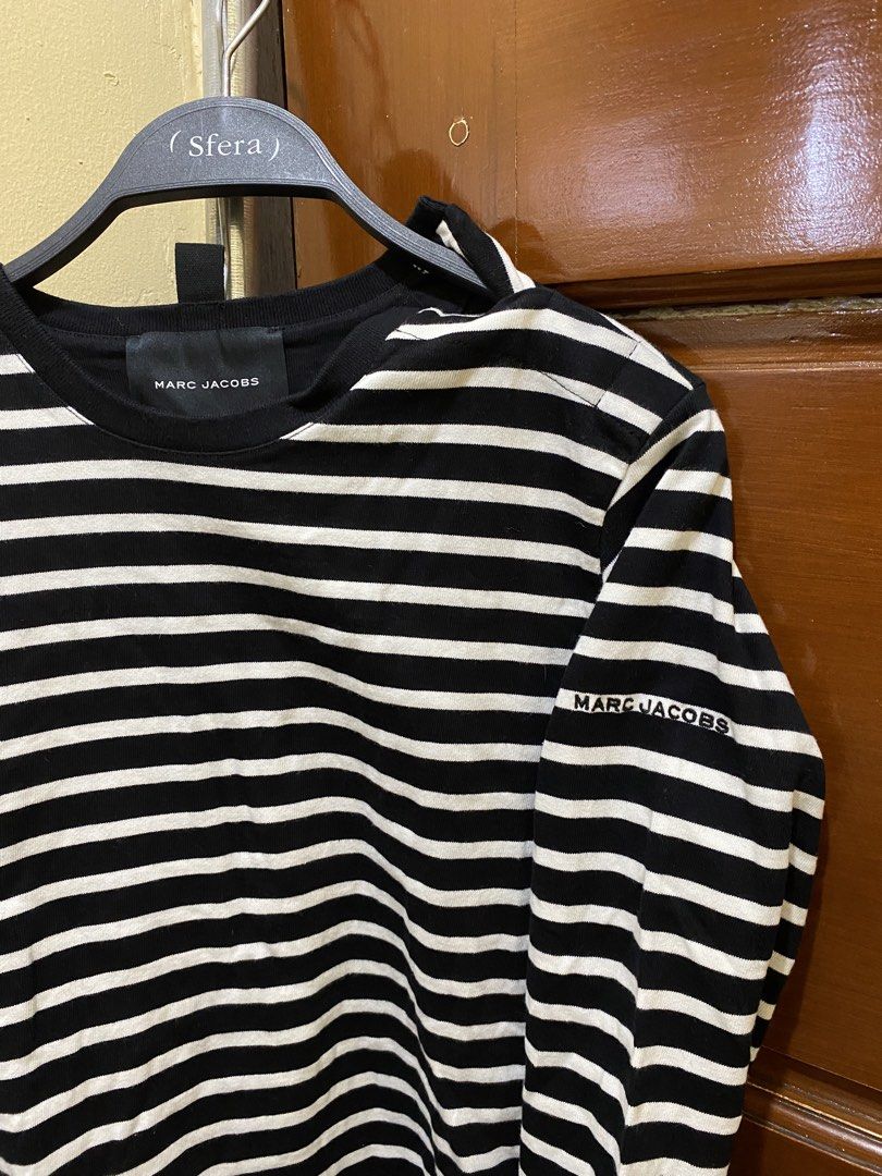 Marc Jacobs Striped Long Sleeve Shirt (Category: Longsleeves) located in Manila. Submitted by haveago0dthrift (Listing ID 1460151296, Image 1). Description: - Classic black and white striped long-sleeved shirt - Brand: Marc Jacobs - Subtle brand name detail on sleeve - Larger tag detail on the side - Material: 100% Cotton - Made in Portugal - Comfortable and stylish for everyday wear - Versatile wardrobe staple - Width 1.5 - Length 4.