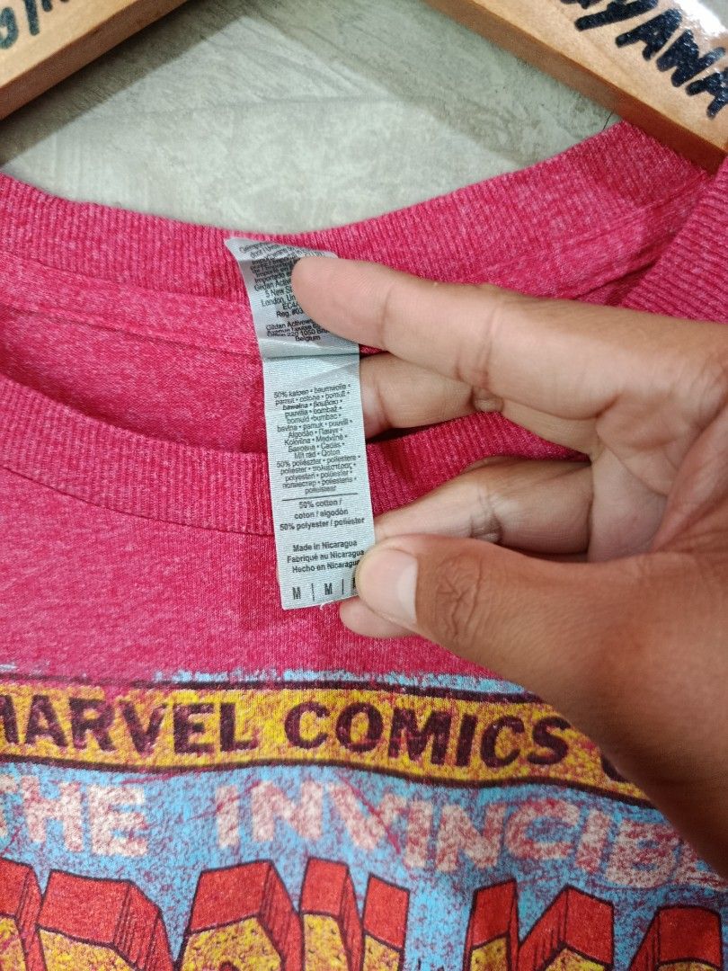 Marvel Comics Iron Man Graphic T-Shirt (Category: Tshirts & Polo Shirts ) located in Kalamansig. Submitted by skone1996 (Listing ID 1460248554, Image 3). Description: - Pink Gildan t-shirt - Features Iron Man comic graphic - Includes Marvel Comics Group logo - Text: 'The Invincible Iron Man' - Material: Cotton blend - Size: Medium - 21 Width - 28 Length - 9.8/10 Color rate - No Issue - Ideal for Marvel fans.