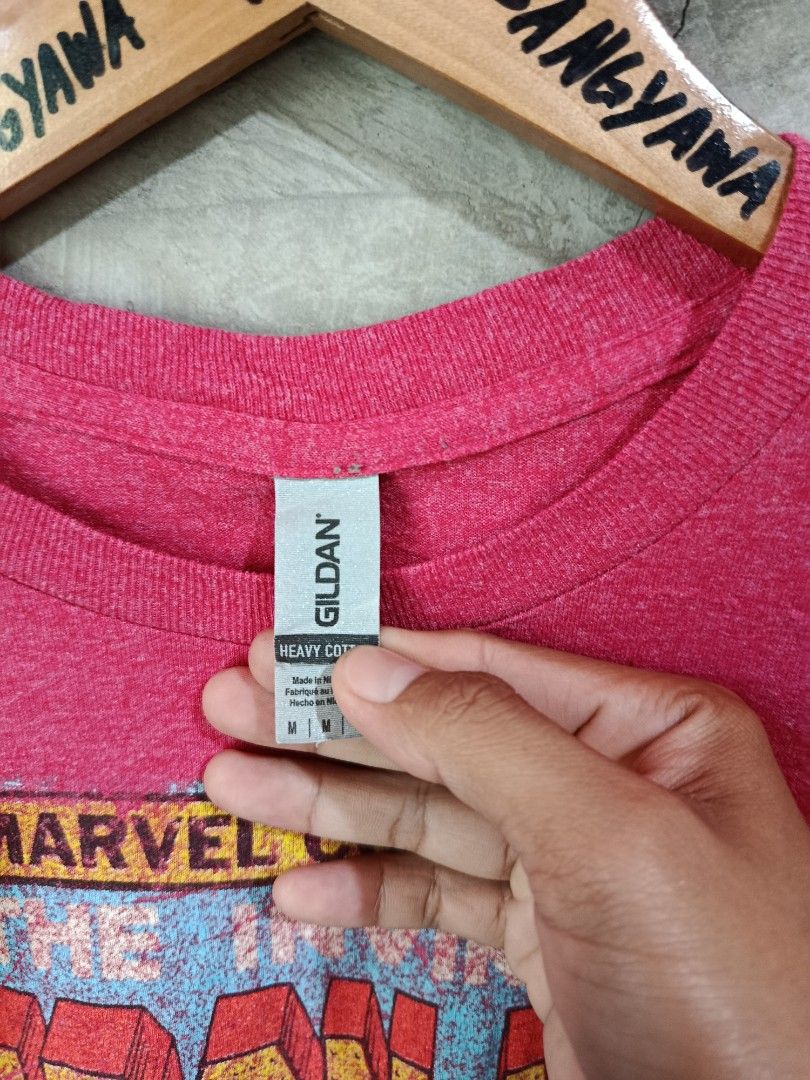 Marvel Comics Iron Man Graphic T-Shirt (Category: Tshirts & Polo Shirts ) located in Kalamansig. Submitted by skone1996 (Listing ID 1460248554, Image 2). Description: - Pink Gildan t-shirt - Features Iron Man comic graphic - Includes Marvel Comics Group logo - Text: 'The Invincible Iron Man' - Material: Cotton blend - Size: Medium - 21 Width - 28 Length - 9.8/10 Color rate - No Issue - Ideal for Marvel fans.