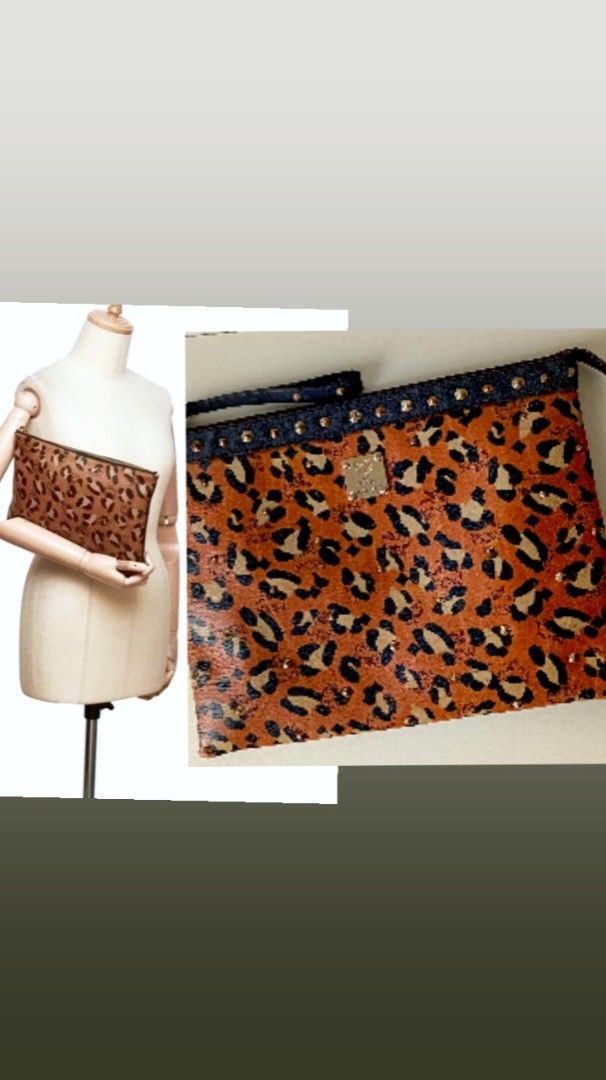 MCM Leopard Print Studded Clutch Bag (Category: Luxury Bags & Wallets) located in Navotas City. Submitted by riyuwi (Listing ID 1460163448, Image 2). Description: PreOwned lightly Used Authentic MCM leopard Printed Studded leather clutch bag Large - Classic MCM monogram with leopard print overlay - Edgy studded details along the top edge - Interior zippered pocket - Ideal for carrying your essentials Sign of Used Good Condition 8.9/10 .