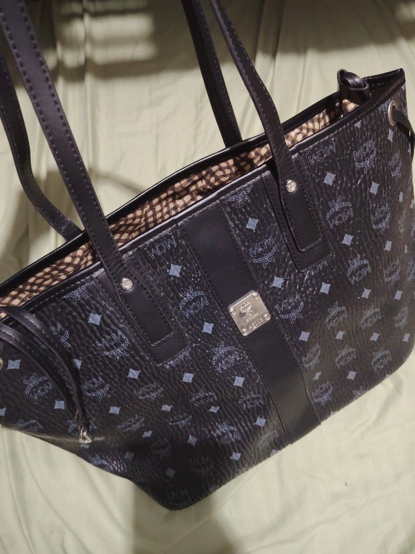 MCM Monogram Tote Bag (Category: Luxury Bags & Wallets) located in Santa Rosa. Submitted by RRRR0520 (Listing ID 1460304624, Image 1). Description: - Classic MCM tote bag - All-over MCM monogram pattern - Black leather trim and straps - Interior features checkered lining - Spacious main compartment WHAT U C S WHAT U GET PLEASE CHECK PHOTOS SIGN OF USED .