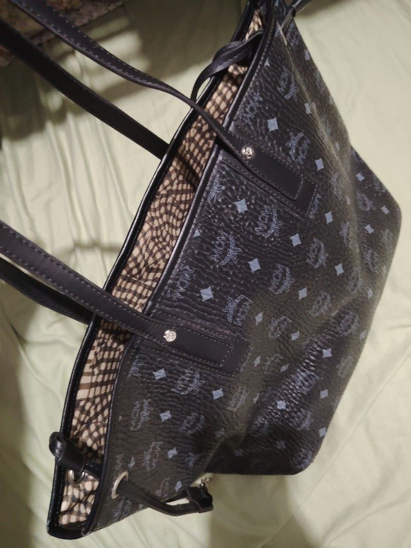 MCM Monogram Tote Bag (Category: Luxury Bags & Wallets) located in Santa Rosa. Submitted by RRRR0520 (Listing ID 1460304624, Image 2). Description: - Classic MCM tote bag - All-over MCM monogram pattern - Black leather trim and straps - Interior features checkered lining - Spacious main compartment WHAT U C S WHAT U GET PLEASE CHECK PHOTOS SIGN OF USED .