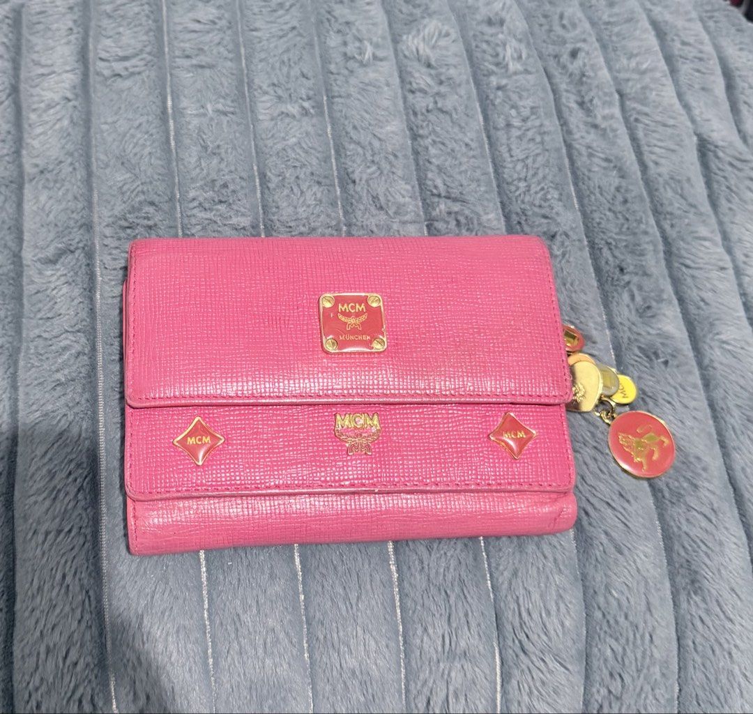 MCM Princess Studded Charm Trifold Wallet (Category: Wallets & Card holders) located in Manila. Submitted by prelovedbygayle (Listing ID 1460279752, Image 1). Description: Leather & Profile: Features an elegant, textured crossgrain or Saffiano-style leather construction across a multi-compartment trifold flap silhouette. Signature Hardware & Studs: Embellished with unique raised diamond-shaped leather appliques and gold-tone logo-engraved diamond