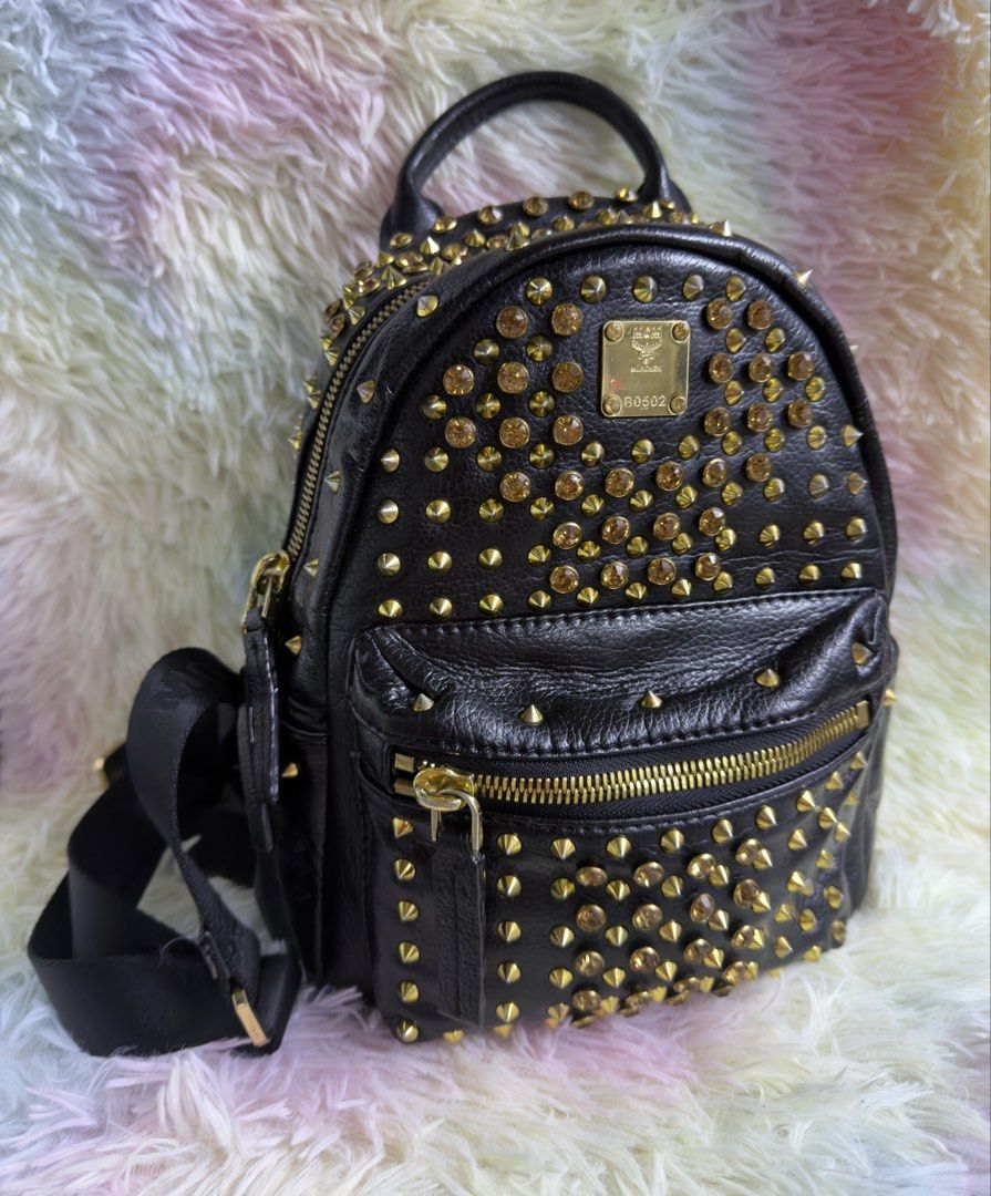 MCM Studded Mini Backpack (Category: Luxury Bags & Wallets) located in Rizal. Submitted by affordabagz (Listing ID 1460225304, Image 1). Description: ⚠️ Condition: • Outside conditioned with leather conditioner ✨ • Interior NOT fully clean — signs of use present 🫧 • Edges & corners show wear / rubbing — see photos 📸 • Zippers & hardware tarnish / discoloration — see close-ups • All photos show actual condition — zoom to see details! ❗ IMPORTANT