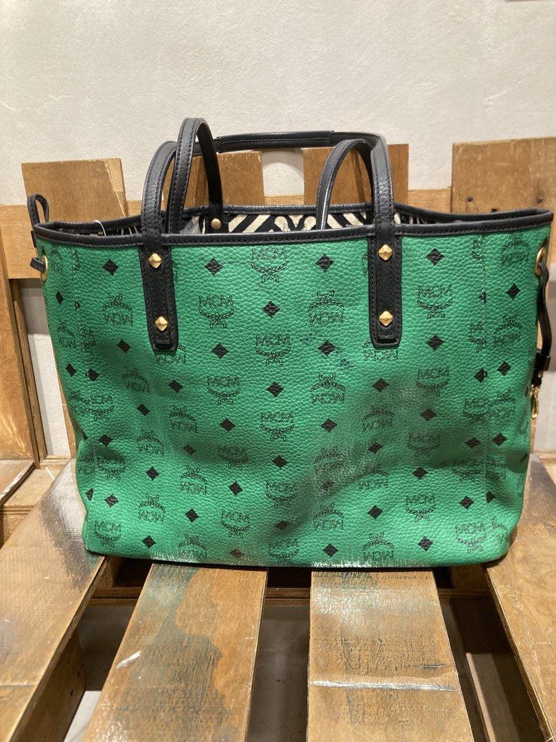 MCM Visetos Green Tote Bag (Category: Luxury Bags & Wallets) located in Quezon City. Submitted by janisu0303 (Listing ID 1460294475, Image 3). Description: - Authentic MCM tote bag - 10,500 php - Signature Visetos pattern all over - Black trim and handles - Gold-tone hardware - Spacious interior, ideal for everyday use - Interior lining with black and white pattern - Snap closure on sides This Reversible shopper tote from MCM has been fabulously 