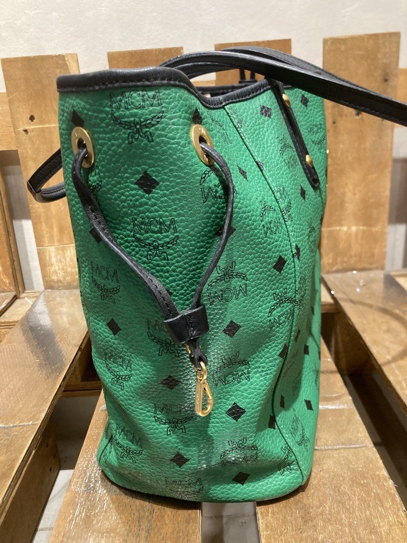 MCM Visetos Green Tote Bag (Category: Luxury Bags & Wallets) located in Quezon City. Submitted by janisu0303 (Listing ID 1460294475, Image 2). Description: - Authentic MCM tote bag - 10,500 php - Signature Visetos pattern all over - Black trim and handles - Gold-tone hardware - Spacious interior, ideal for everyday use - Interior lining with black and white pattern - Snap closure on sides This Reversible shopper tote from MCM has been fabulously 