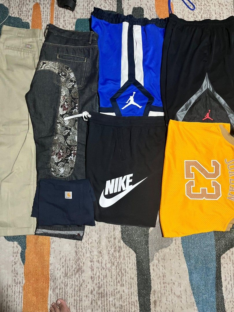 Men's Apparel Bundle: Nike, Jordan, Carhartt, & More (Category: Tshirts & Polo Shirts ) located in Paranaque City. Submitted by angelaesteban (Listing ID 1460266185, Image 1). Description: - Bundle includes: Nike shorts, Jordan basketball shorts, Jordan jersey, Carhartt shorts, and casual pants. - Perfect mix of athletic and casual wear. - All items are in good, pre-owned condition. - Ready for a new owner. - Excellent value for the lot..